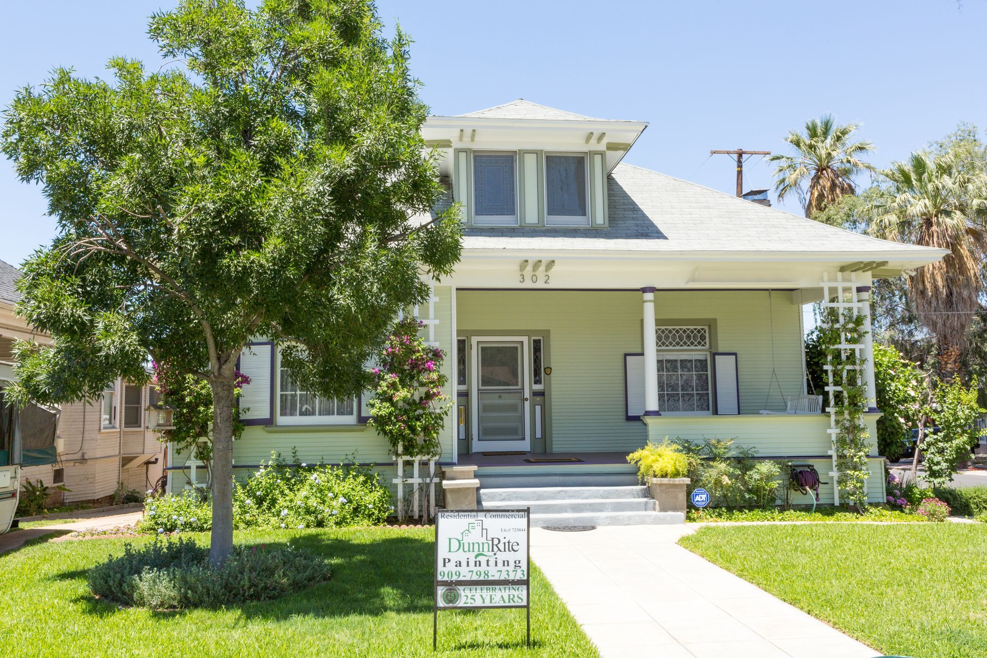 A house with a for sale sign in front of it