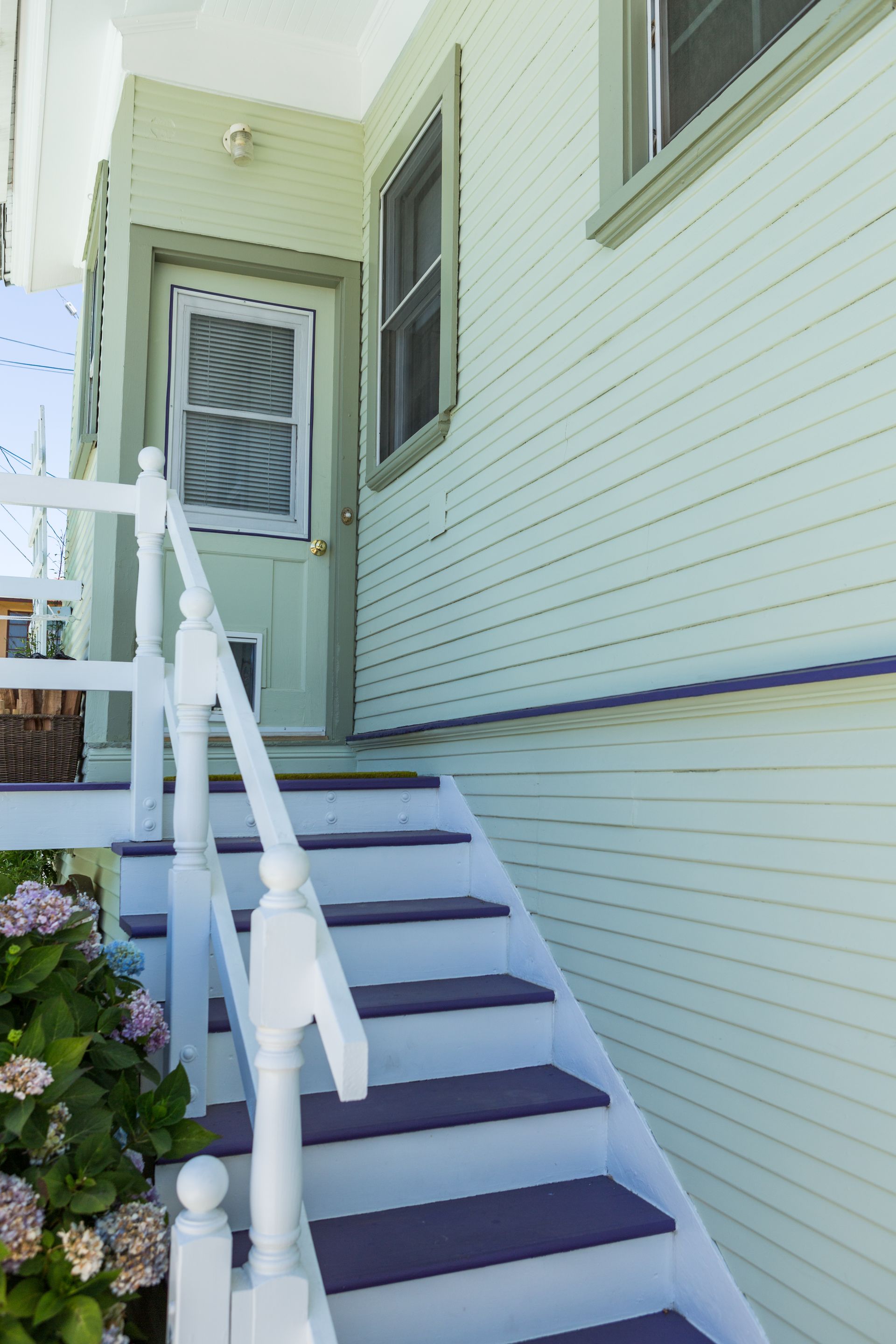 A set of stairs leading up to the front door of a house.