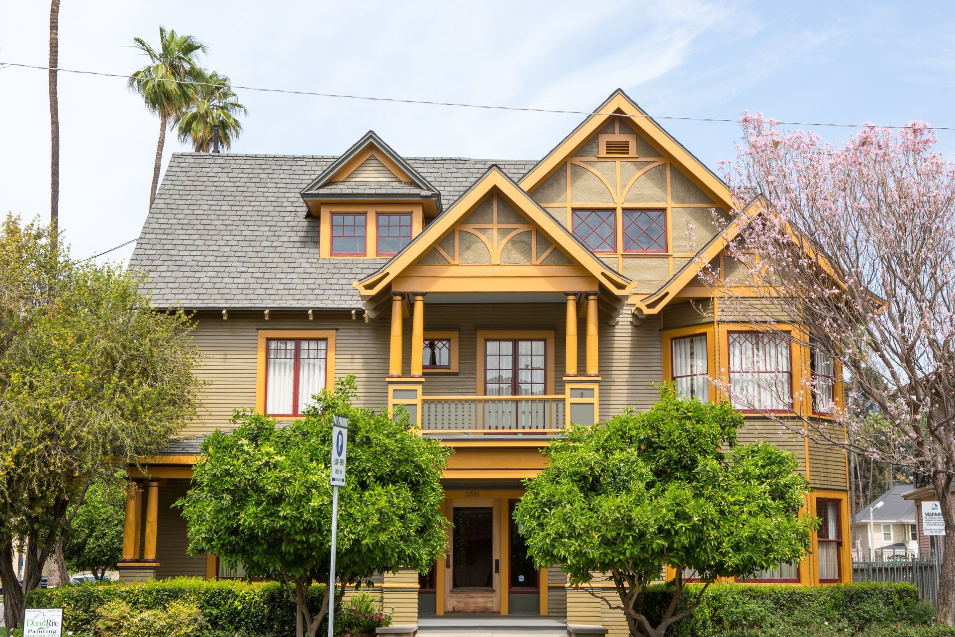 A large house with a lot of windows and trees in front of it