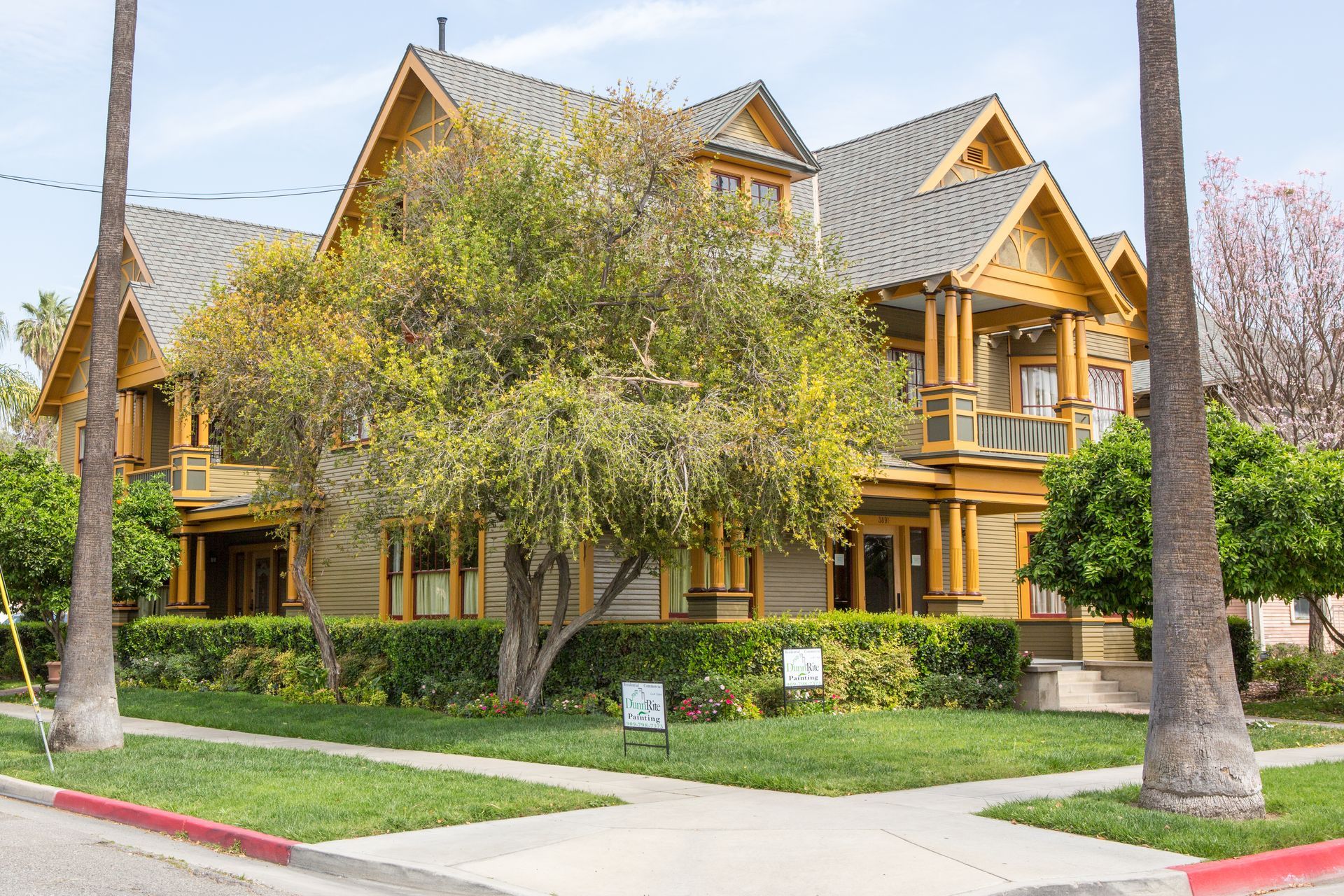 A large house with a lot of trees in front of it