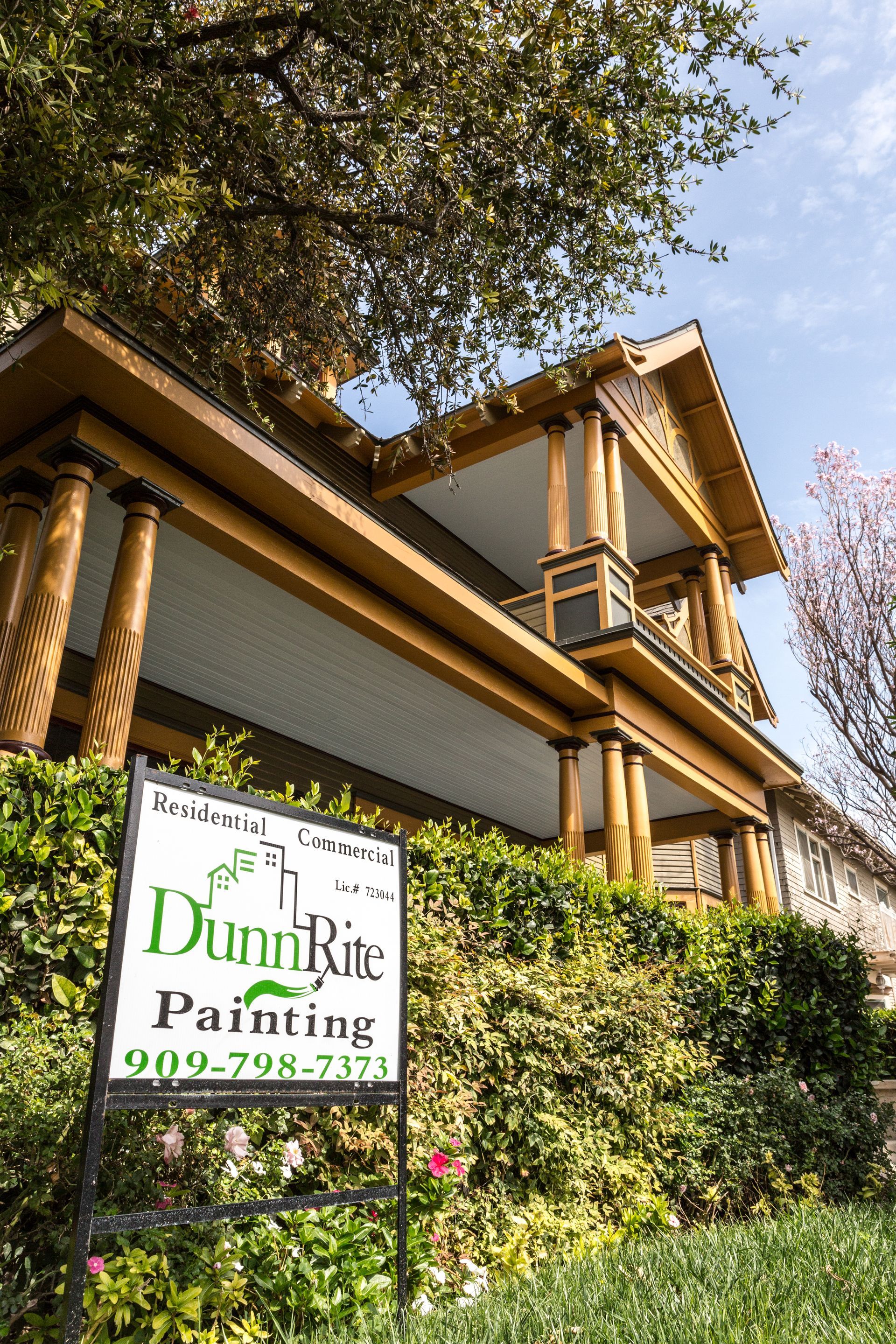A large house with a sign in front of it that says dunn rite painting