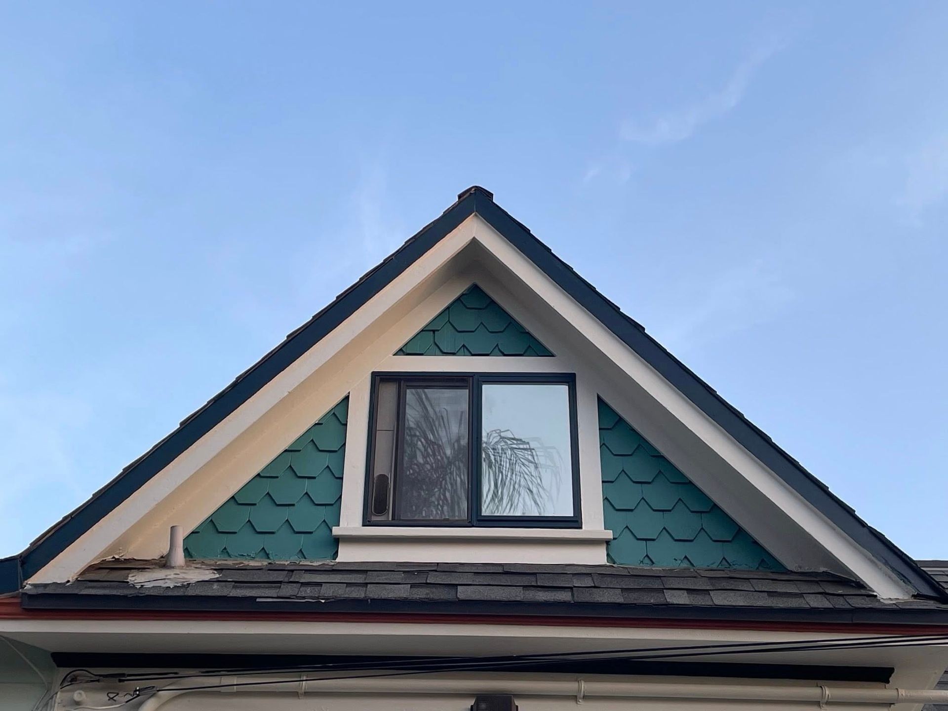 A house with a triangle roof and a window