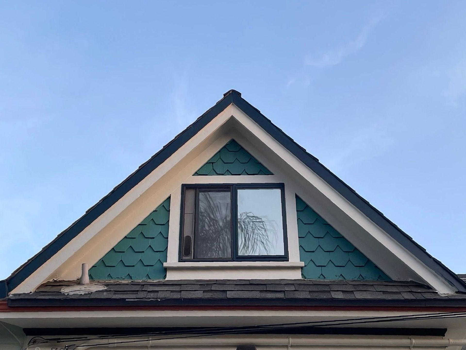 A house with a triangle roof and a window