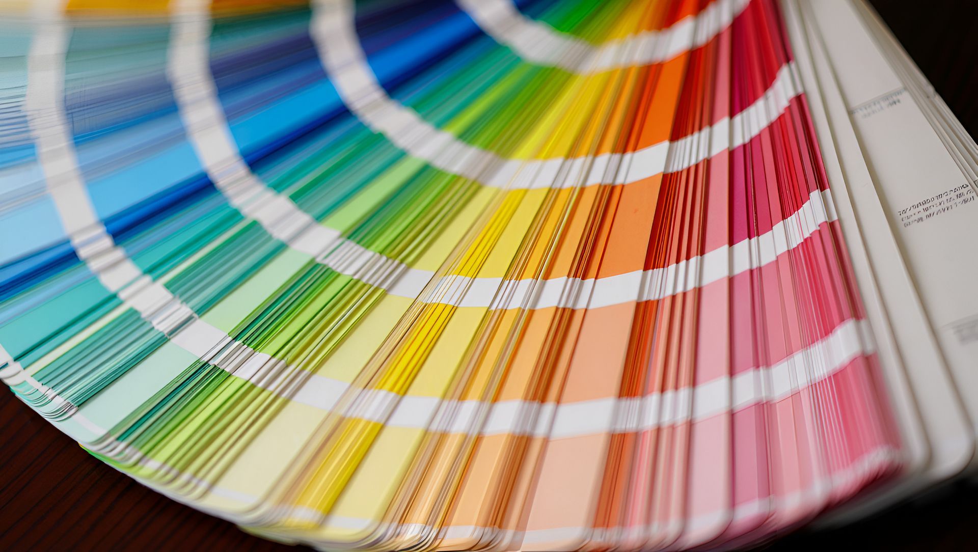 A close up of a color swatch book on a table.
