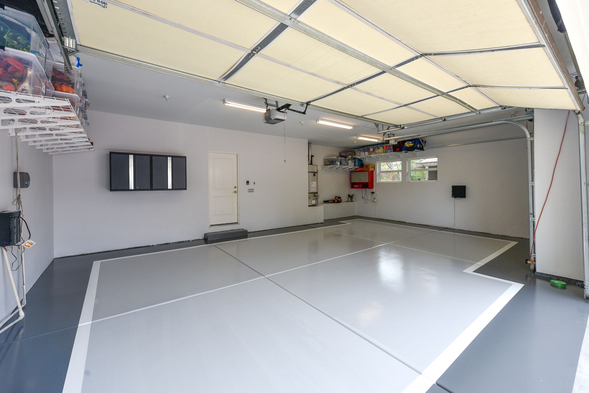 A hallway with a table and a picture on the wall.