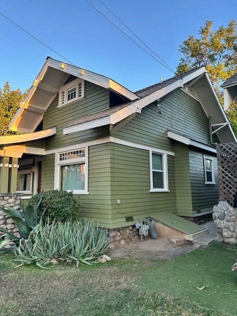 A house with green siding and white trim