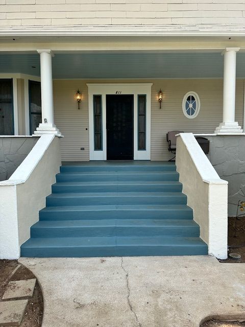 A house with blue stairs leading up to the front door