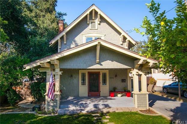 The front of a house with a car parked in front of it