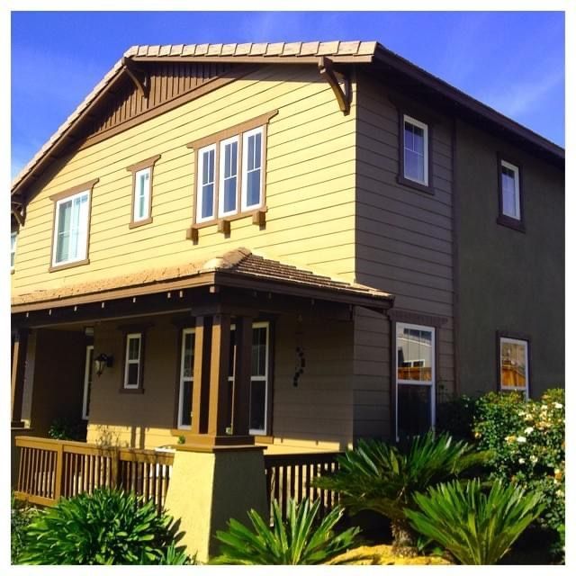 A house with a porch and a blue sky in the background