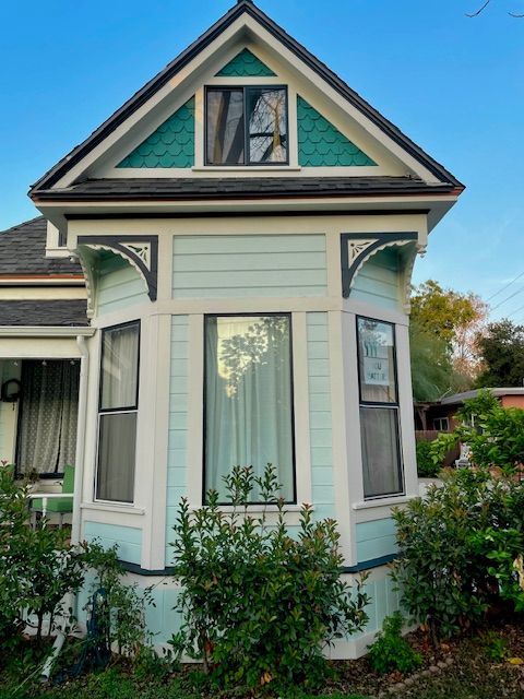 A small house with a green triangle on the roof