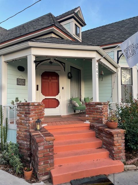 The front of a house with a porch and stairs