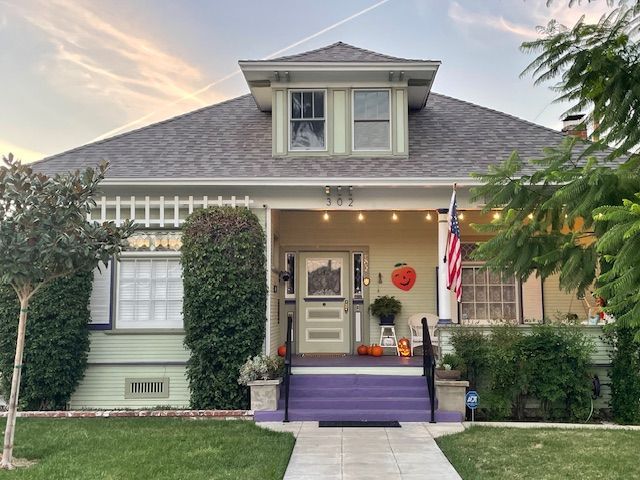 The front of a house with a purple porch and stairs