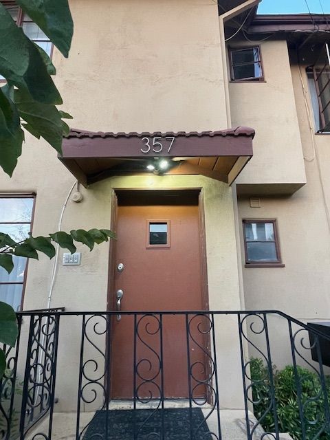 The front door of a house with the number 357 on it