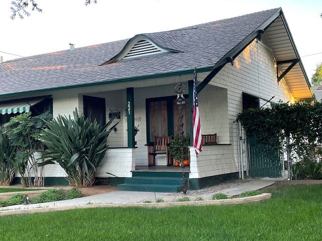 A house with a porch and an american flag on it