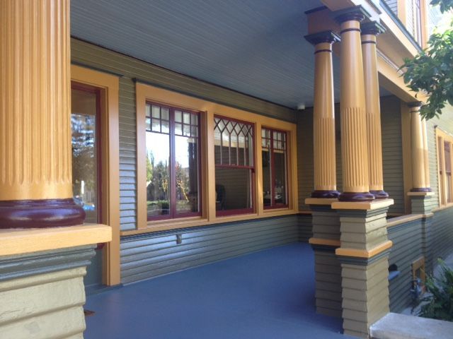 A porch with columns and a lot of windows
