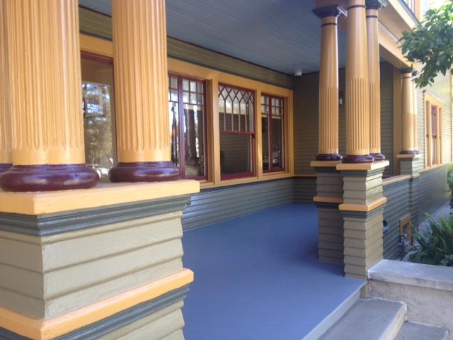 A porch of a house with columns and stairs