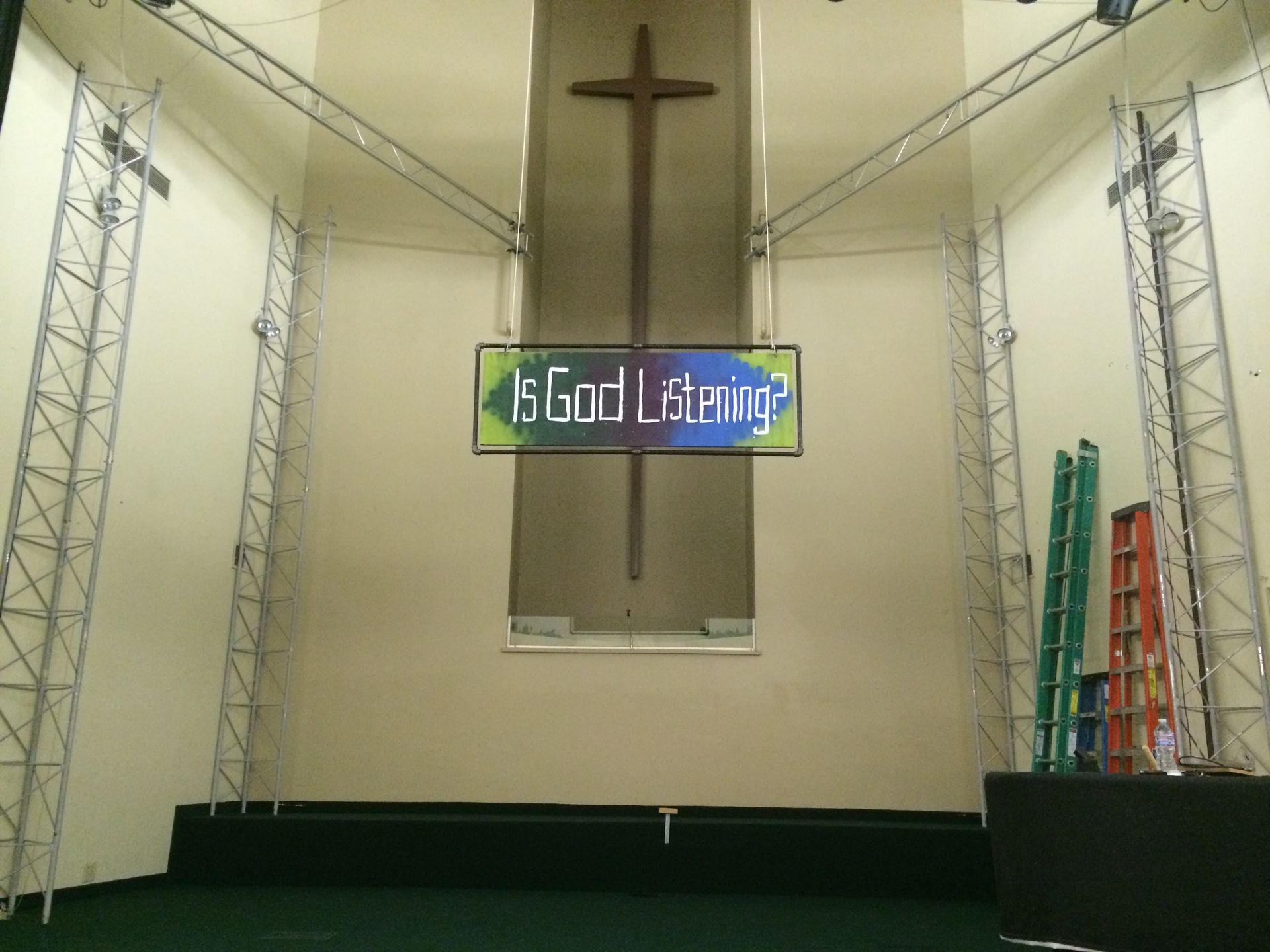 A freshly painted  church with a cross and a sign that says god lighting