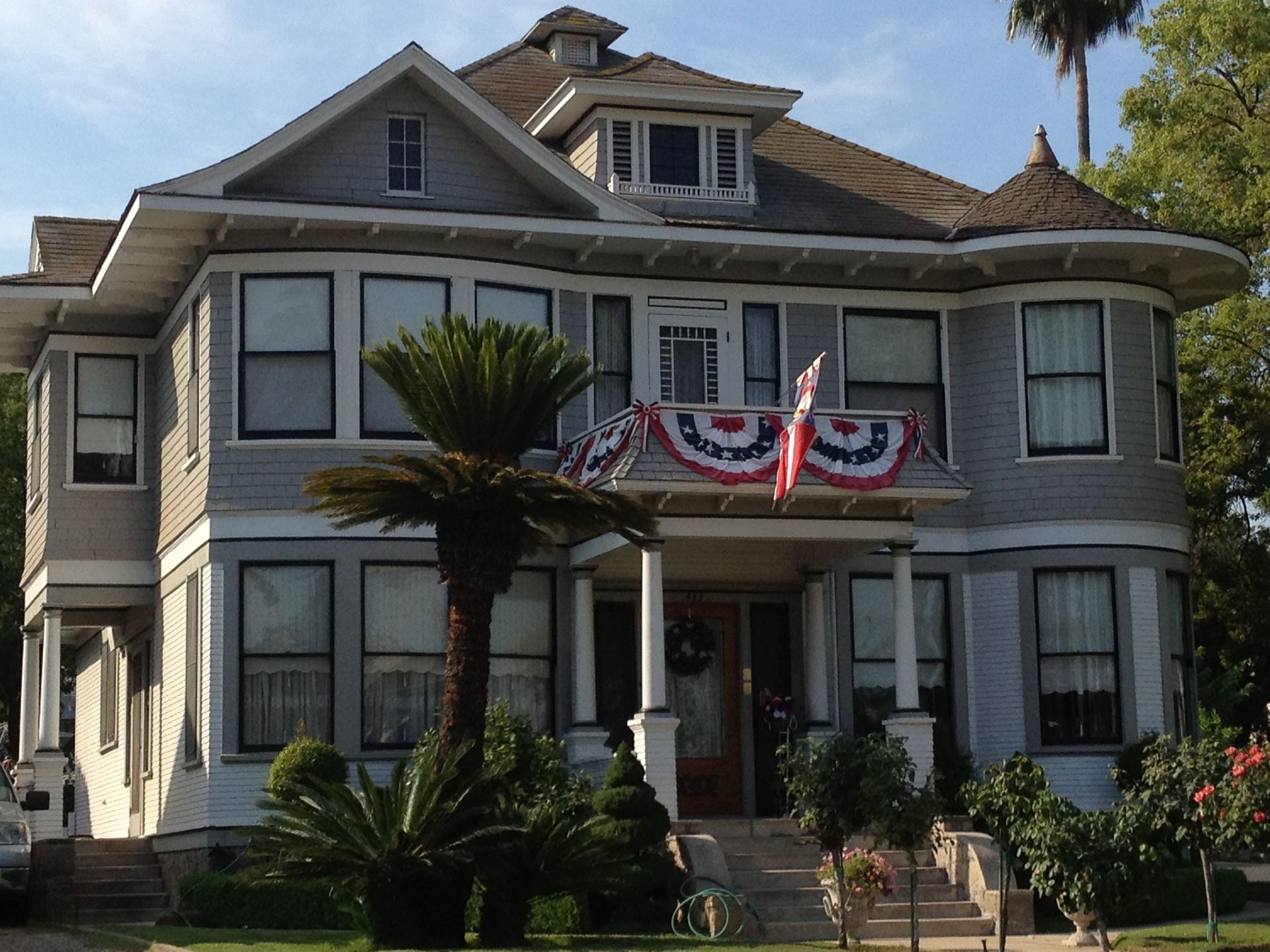 A large house with a palm tree in front of it