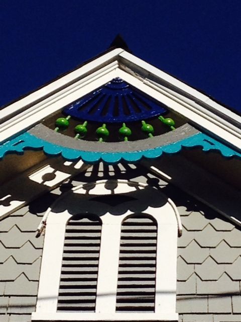 The roof of a house has a blue and green decoration on it