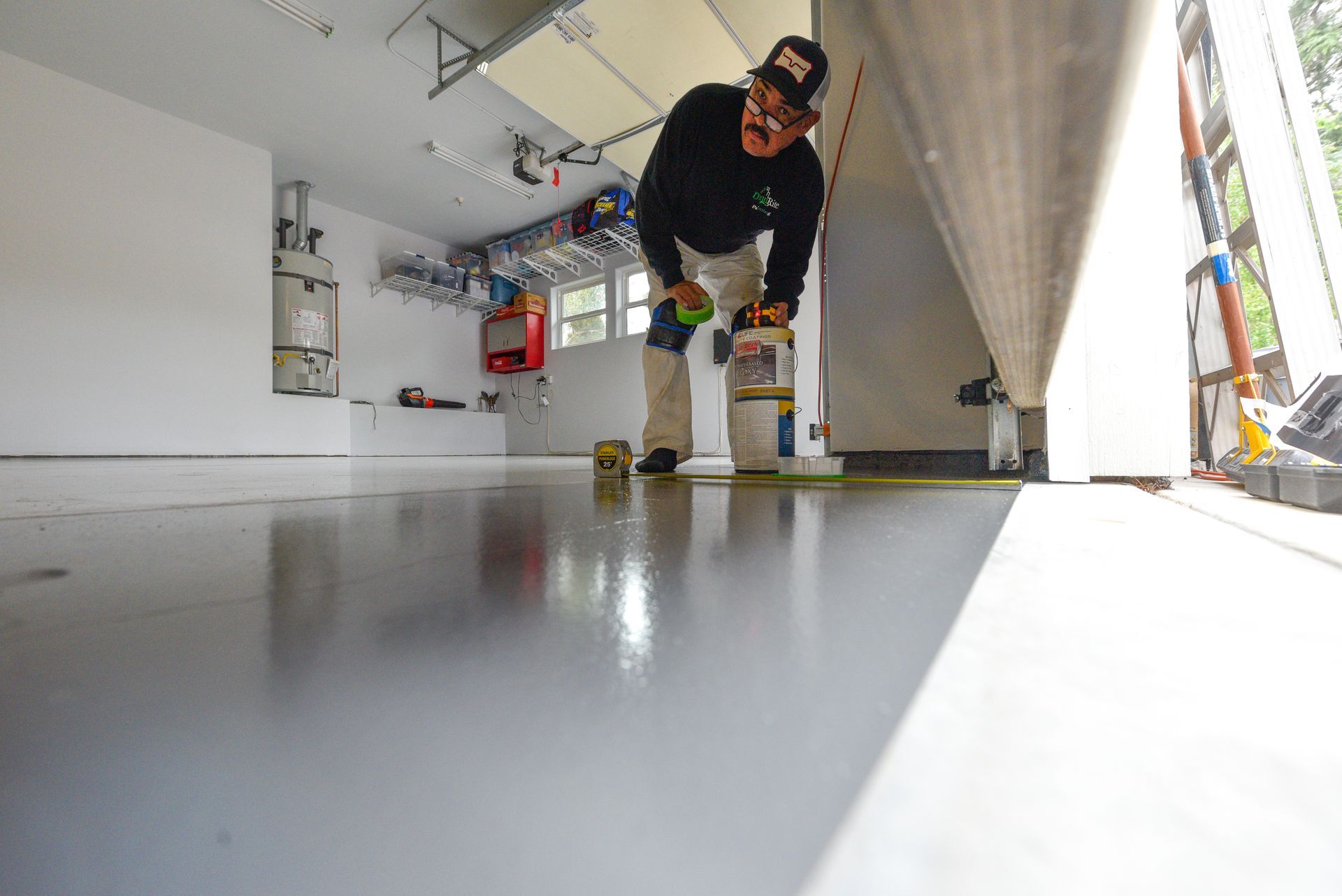 A person is using a hammer to remove mold from a ceiling.