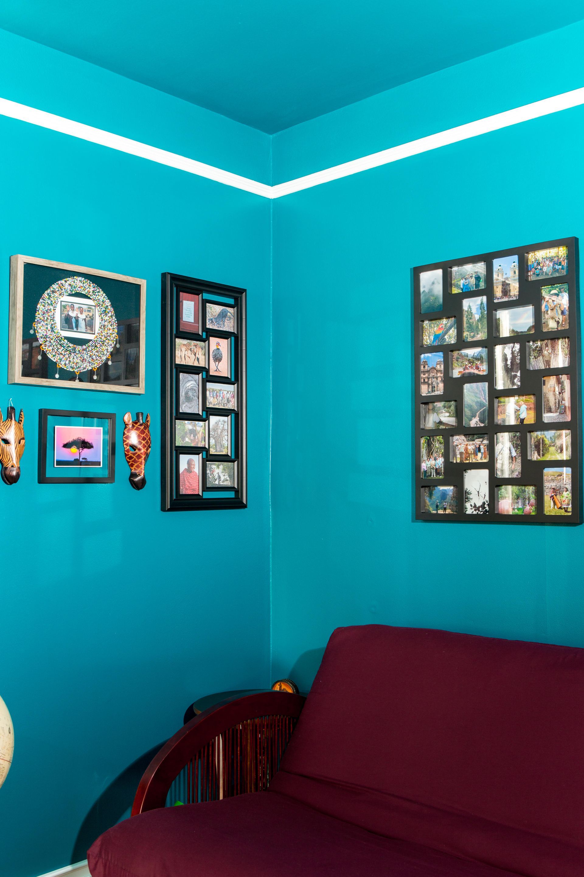 A living room painted blue walls and a red couch.
