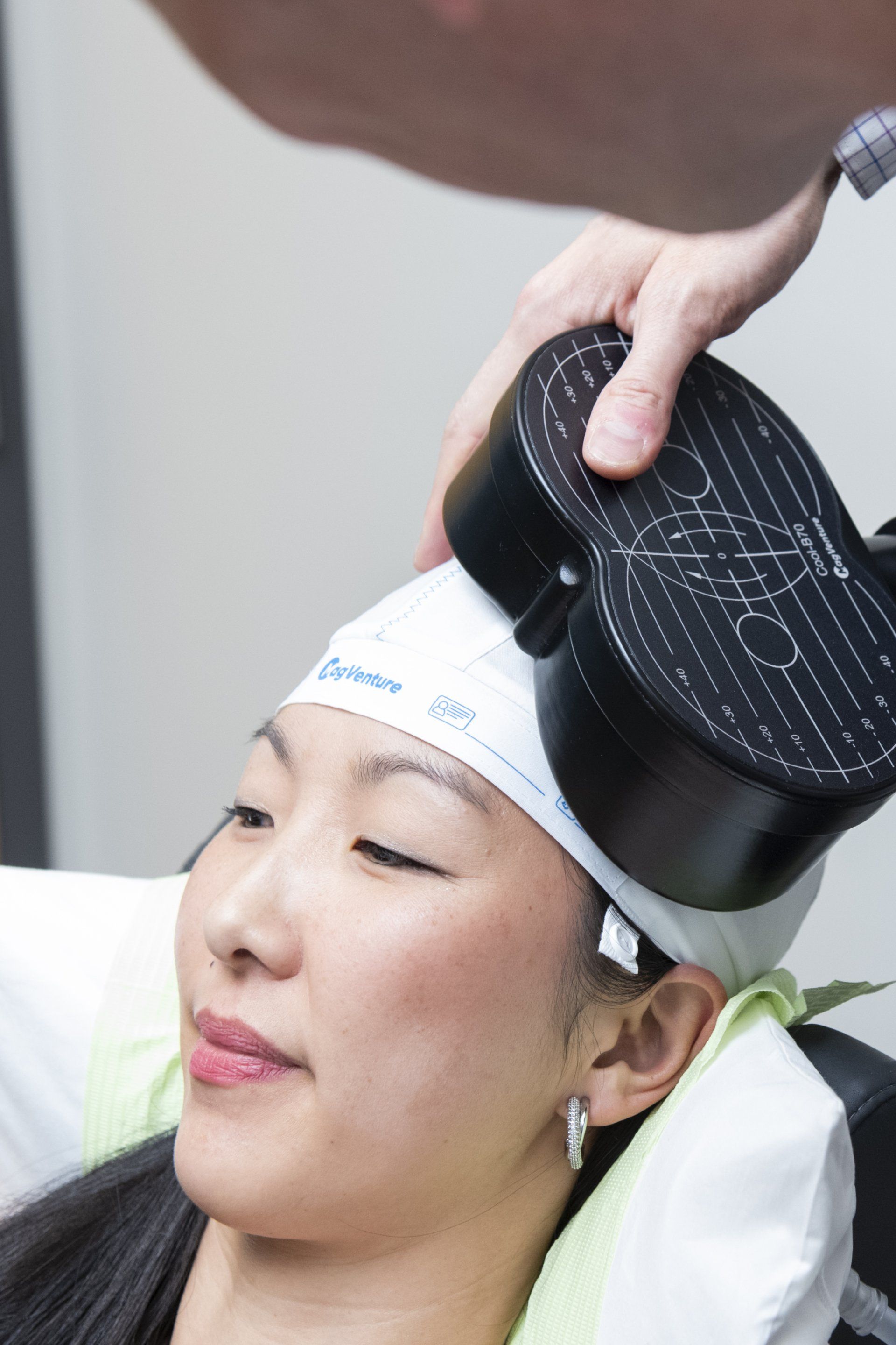 a woman is getting a treatment on her head