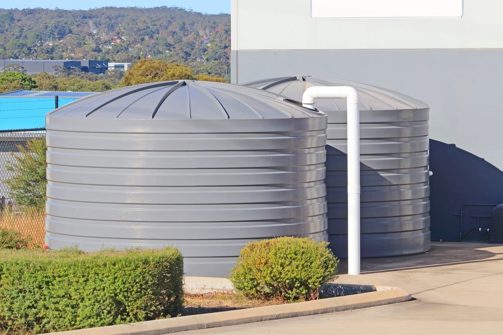Two Large, Gray Water Storage Tanks — Raptor Waste Management in Coolangatta, QLD
