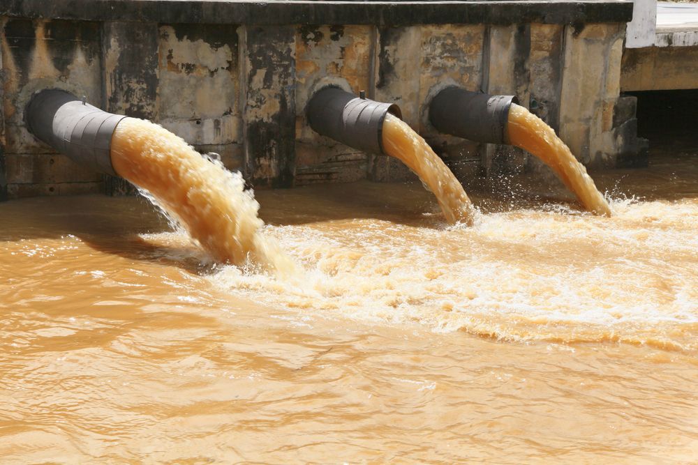 Three Pipes Discharging Brown Water Into a River — Raptor Waste Management In Murwillumbah, NSW