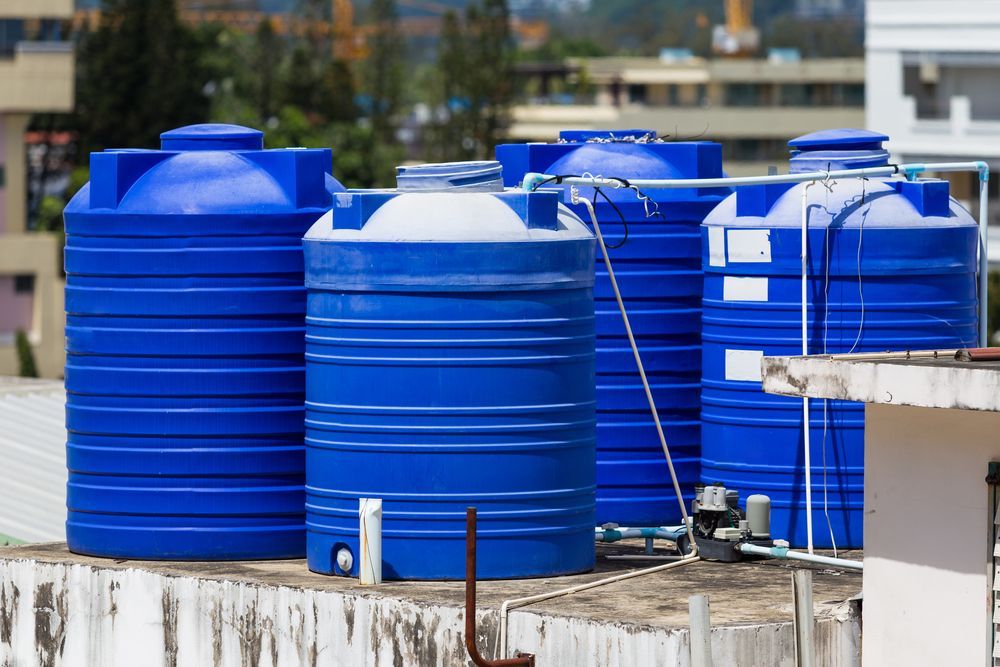 Blue Water Tanks on a Rooftop — Raptor Waste Management In Carrara, QLD