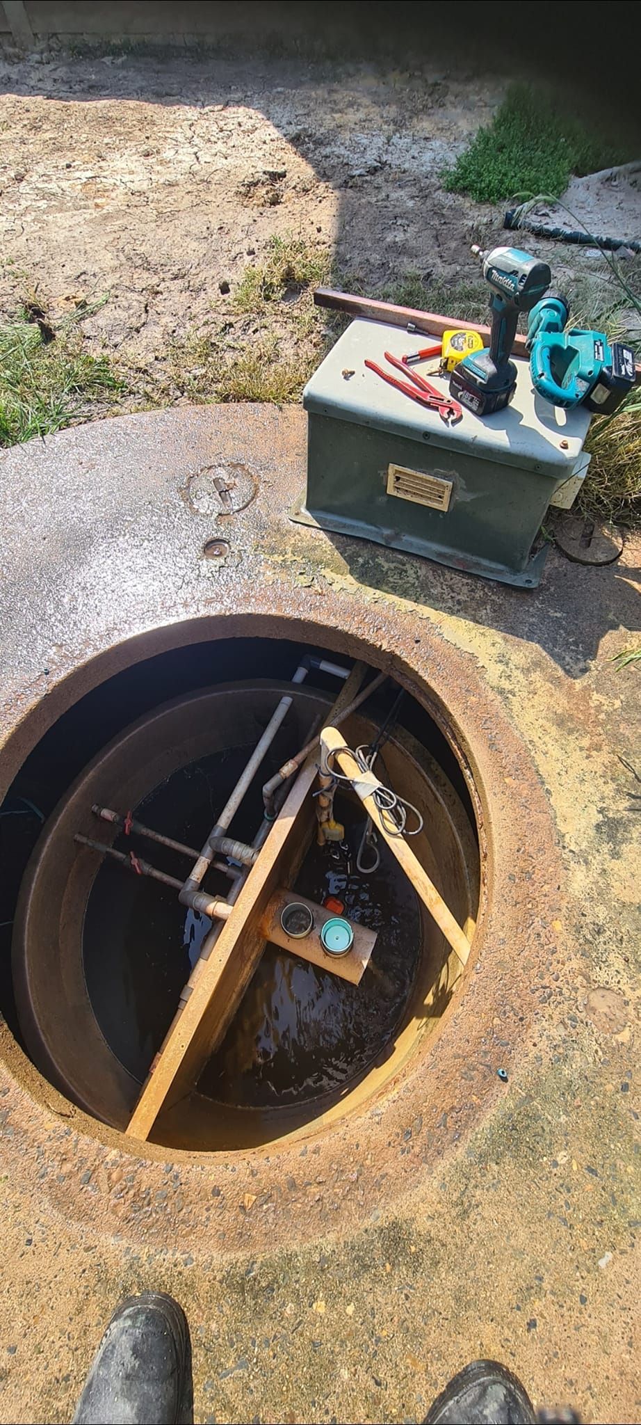 An Open Manhole With Tools and a Toolbox Nearby — Raptor Waste Management in Coolangatta, QLD