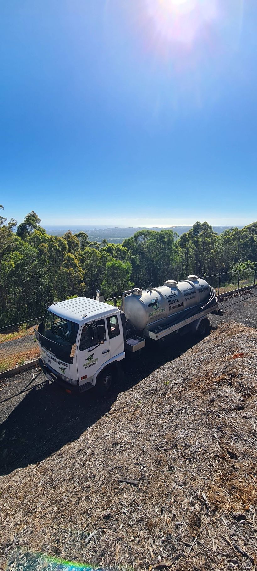 White Truck With a Silver Tank Trailer on a Gravel Road — Raptor Waste Management in Coolangatta, QLD