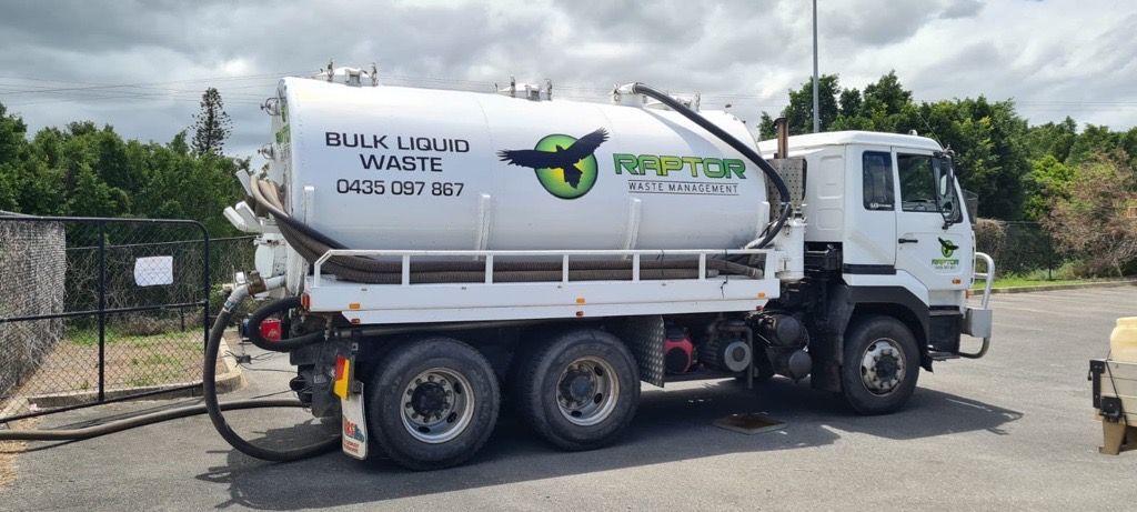 White tanker truck with black hose parked on a paved lot; green logo and text visible on tank. — Raptor Waste Management in Coolangatta, QLD
