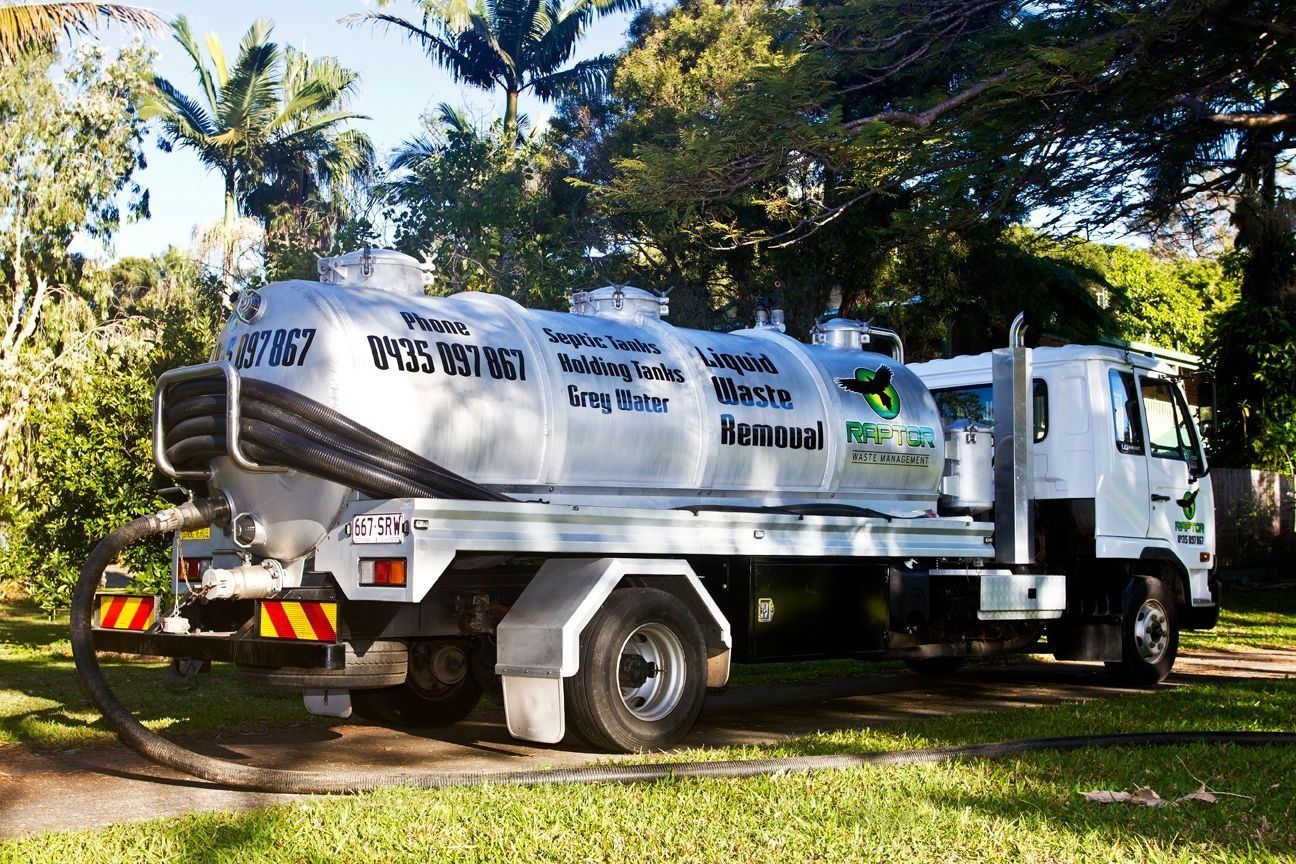 A Silver Septic Tank Truck Parked on Grass — Raptor Waste Management in Coolangatta, QLD