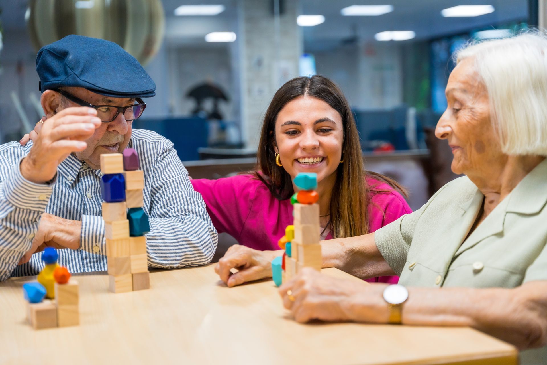 a woman is playing a game with two elderly people in a nursing home .