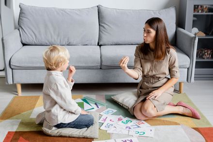 a woman and a child speech therapy
