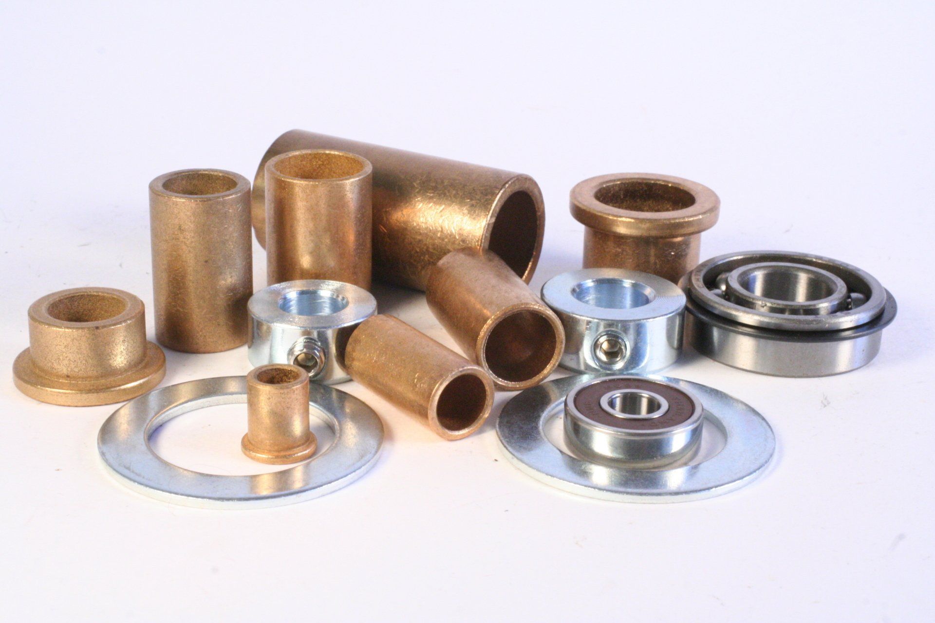 There are many different types of bearings and bushings on the table.