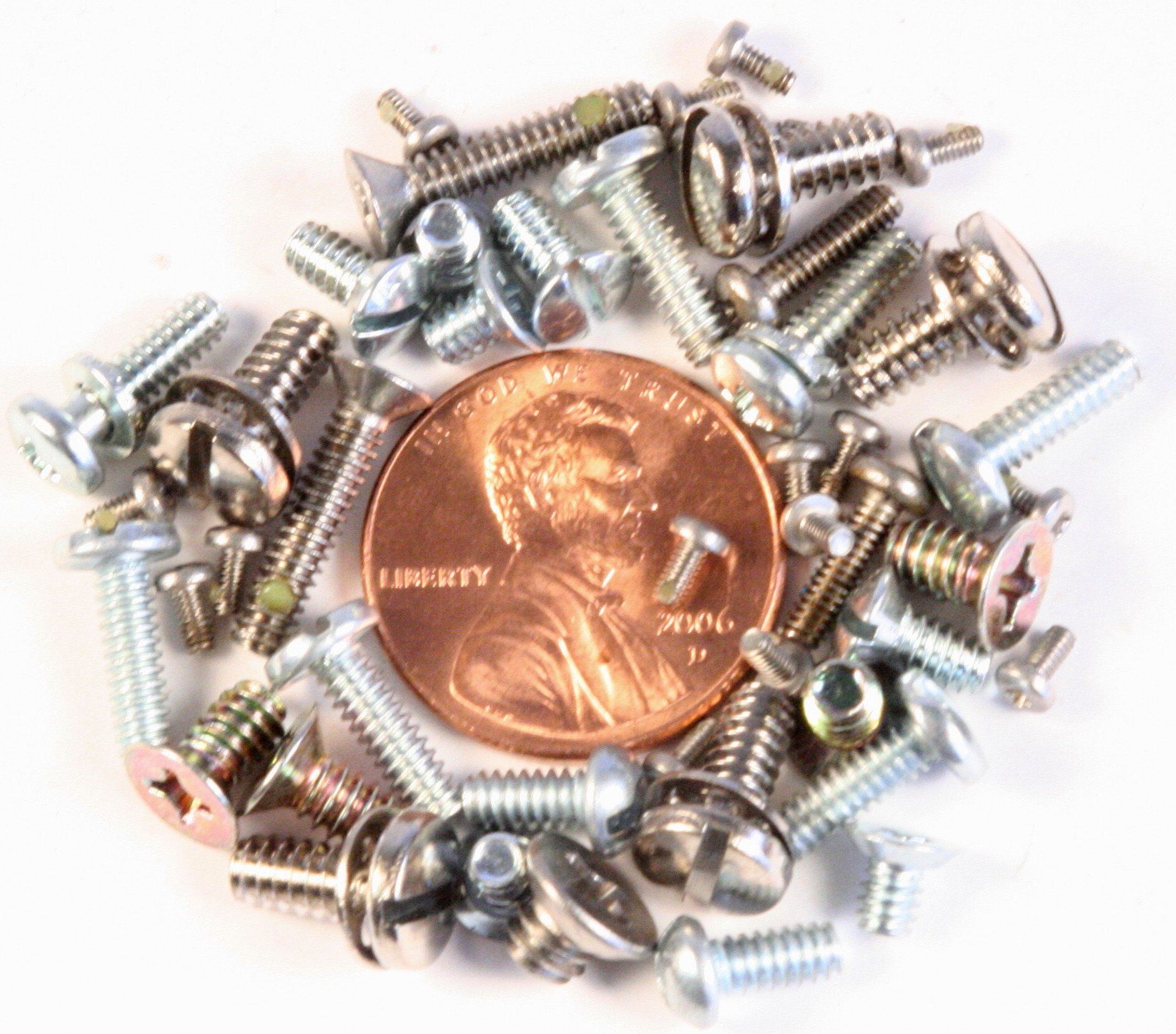 A pile of screws and a penny that says liberty on it