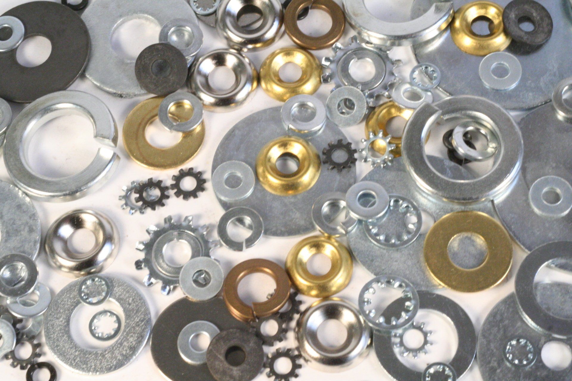 A pile of washers and gears on a white surface