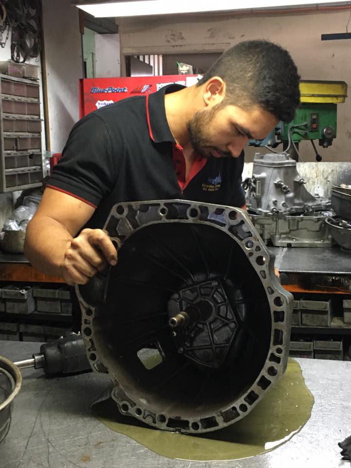 Man holding car driveline part in repair shop | Ingleburn, NSW | Gearbox Express