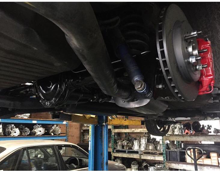 Car without a wheel in repair shop | Ingleburn, NSW | Gearbox Express