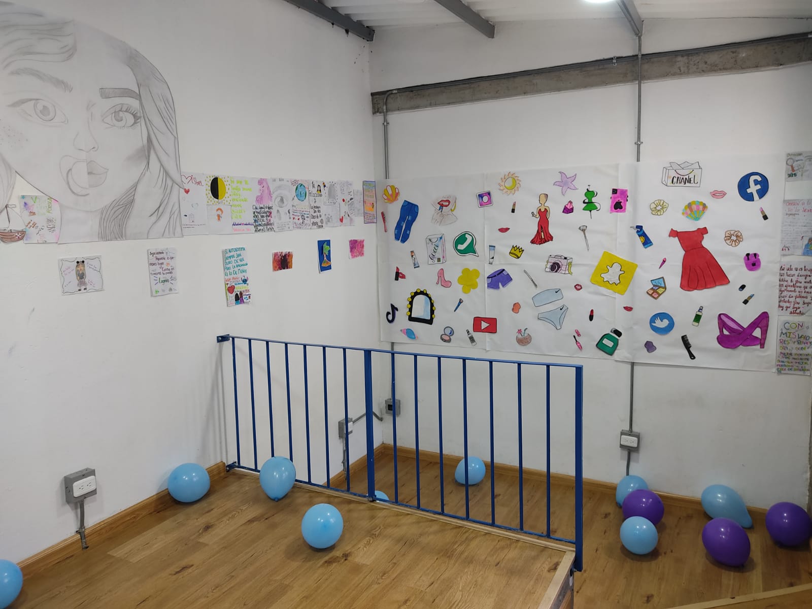 A room with balloons and drawings on the wall