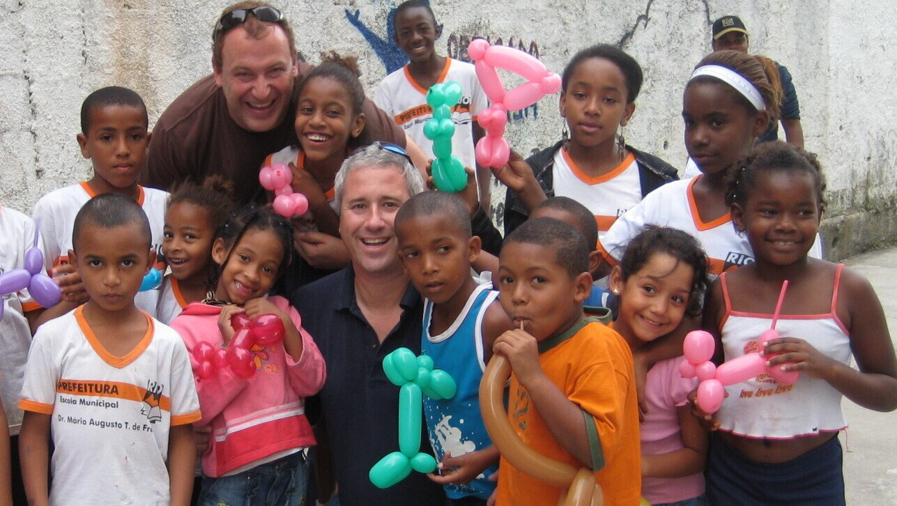 A group of children are posing for a picture with balloons