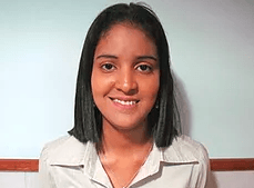 A young woman is smiling for the camera while wearing a white shirt.