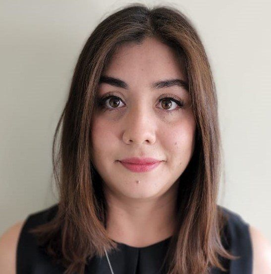 A close up of a woman 's face with a necklace around her neck.