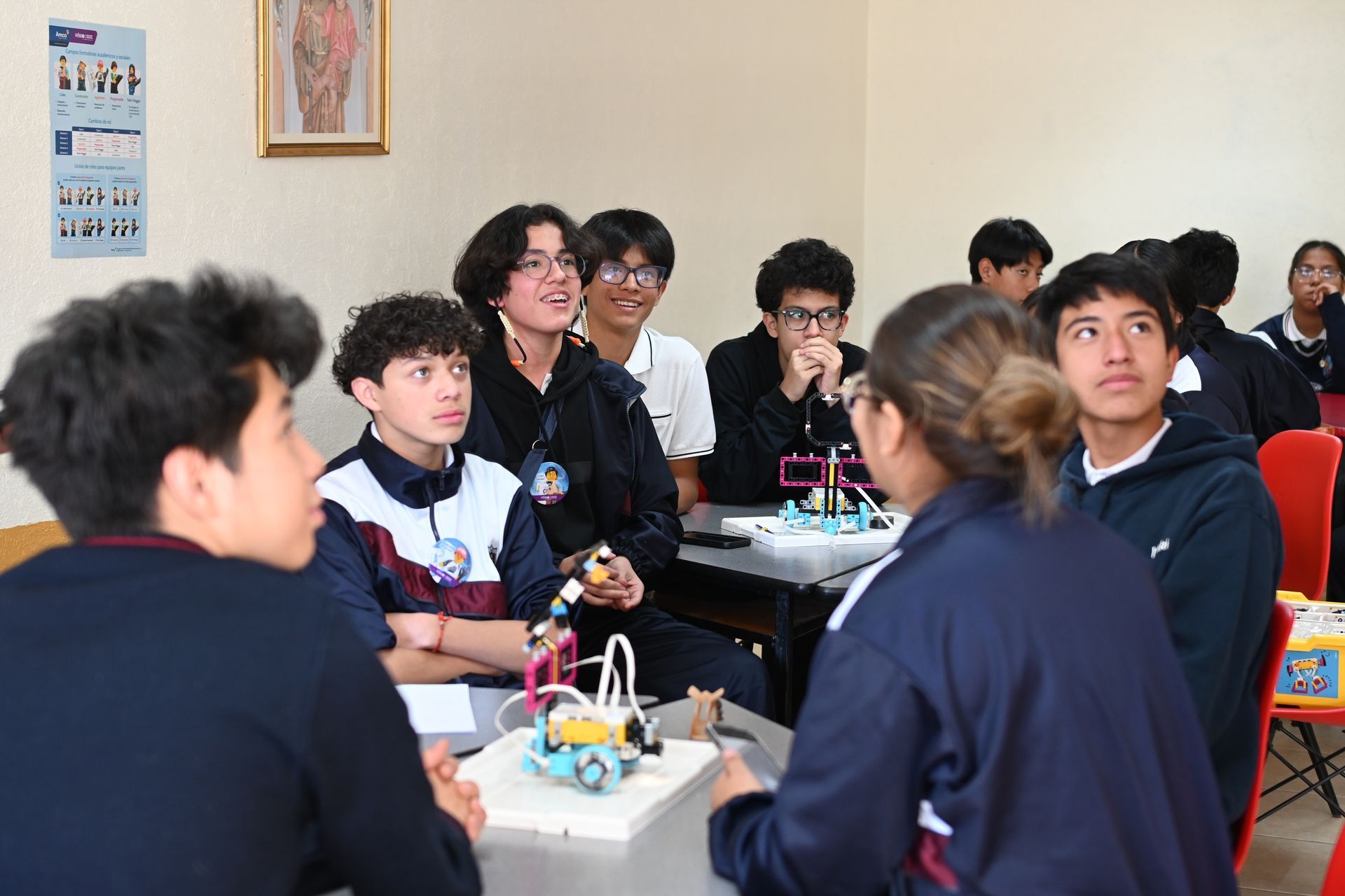 Students observing a demo of a small robotic device. orphaned starfish foundation  andy stein OSF Robotics Initiative stem education