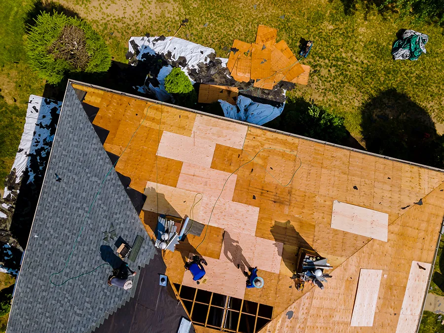 An aerial view of a roof being installed on a house.