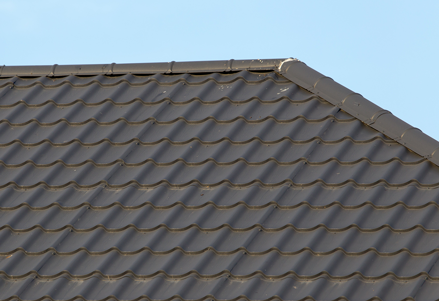 a close up of a roof with a blue sky in the background