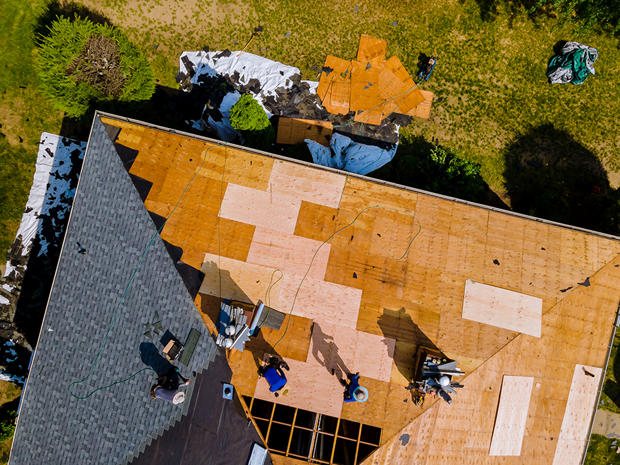 an aerial view of a roof being installed on a house .