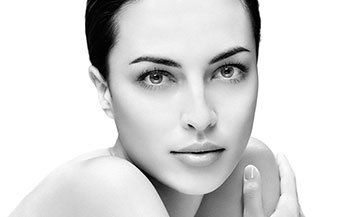 It is a black and white photo of a woman 's face.