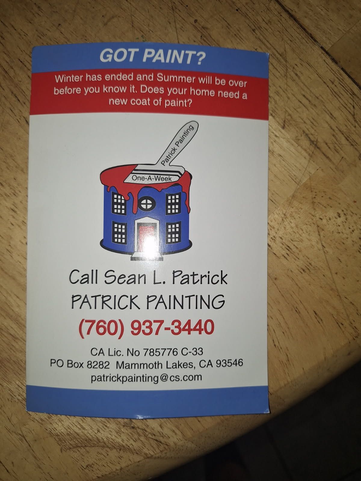 A small dog is taking a bath in a wooden bucket.